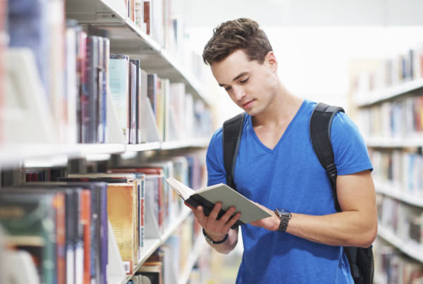 Shot of a young man deep in concentration while reading